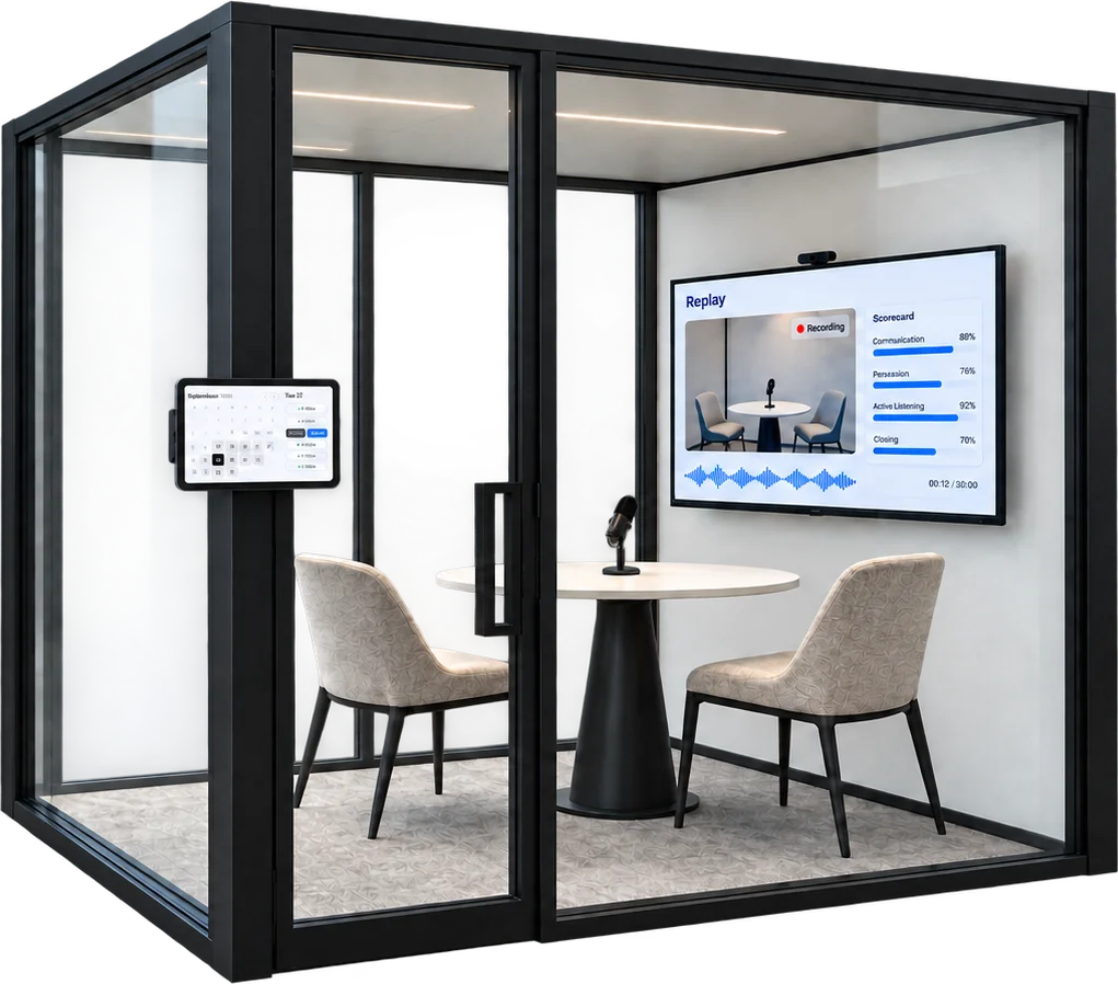 A sales lab room with a booking tablet on the door and a screen showing a live Replay recording and scorecard